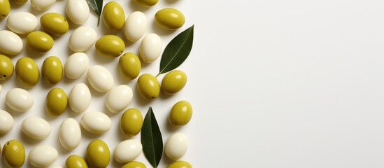 close-up of green and white olives, with some leaves scattered among them. banner with copy space