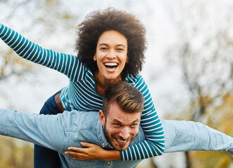 woman couple man happy love young lifestyle together fun friend youth group hugging piggyback...