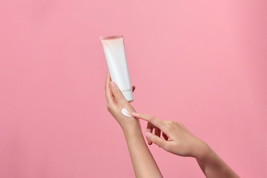 Woman applying lotion to hand