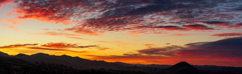 Panorama at sunset, sunrise over silhouetted mountains