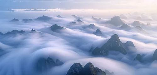 Fotobehang A dense fog rolling over the peaks of a mountain range at dawn, with only the highest points breaking through the cloud cover. 32k, full ultra hd, high resolution © Annu's Images
