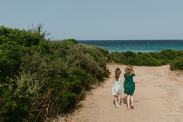 Two friends walking towards beach