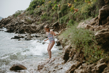 Adventurer girl in rocky beach