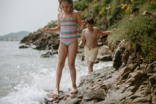 Adventurer kids in rocky beach