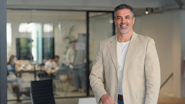 Happy confident middle aged business man ceo manager, 50 years old leader, mature professional lawyer, male company executive owner wearing suit standing arms crossed in office, portrait.