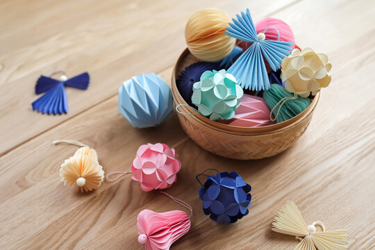 Collection of colourful origami crafts in wooden box on table