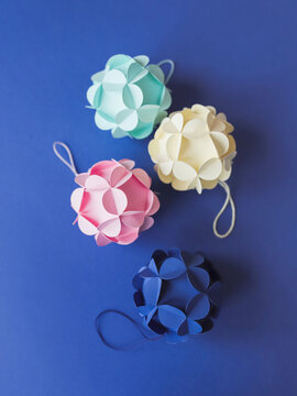 Colorful modular origami balls laying isolated on blue background