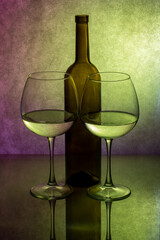 Still life with glassware with liquid on colored background