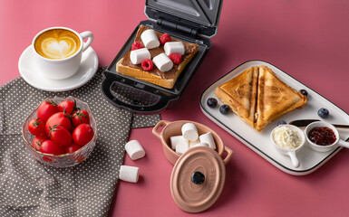 Huge healthy traditional breakfast spread on a table  with a lovely small oven. Healthy breakfast table scene with fruit, Roasted chicken wings, egg tarts, nutritious toasts and egg skillet. 