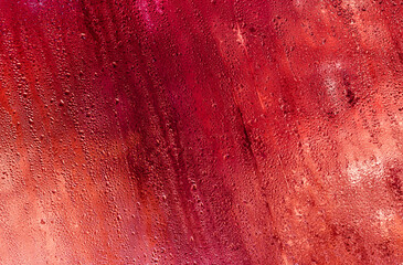abstract background of red wet glass.
