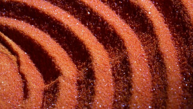 Small bright orange crystals of potassium dichromate, close up, abstract colorful background