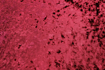 Textured background of deep soft red velour fabric.