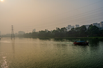 Riverine Commute in Dhaka's Misty Dawn