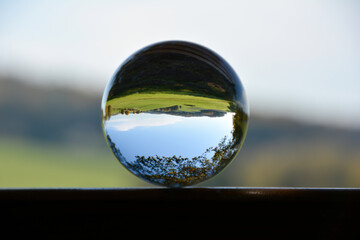 Green landscape reflected in a sphere - 783300874