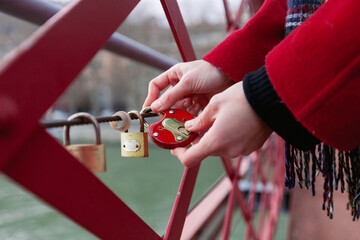 Woman Securing Love on a Bridge