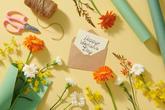 Happy Women's Day postcard with Gerbera flowers on yellow background
