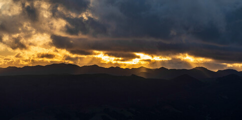 Horizon at sunrise, sunset over mountains, clouds, storm