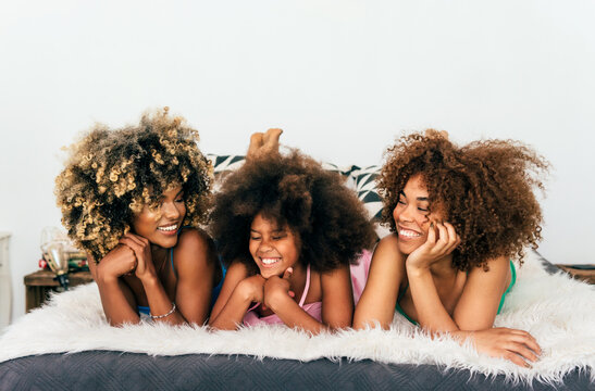 Joyful family moment with mother and daughters laughing
