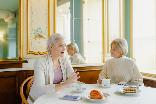 Meeting of two friends in a cafe