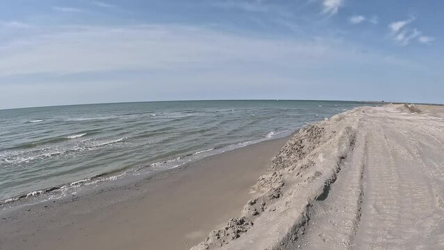 Walking on the sand dunes at the beach under construction in Grado, Italy in spring.