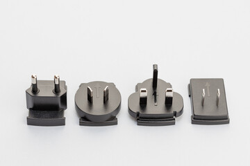 Variety of electrical plugs from different regions worldwide isolated on gray background
