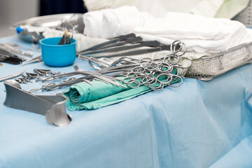 Sterile surgical instruments and tools including scalpels, scissors, forceps and tweezers arranged...
