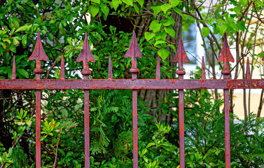rusty spear heads at a garden fence of a villa in the spa community of Bath Voeslau in Lower...