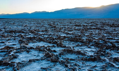 Salt plateau of self-sedimented salt cracked in the heat of the sun in the desert in Death Valley,...