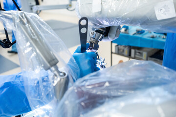 Team of doctor perform total hip arthroplasty replacement surgery in osteoarthritis patient inside the operating room. robot-assisted - robotic hip and knee replacement surgery	