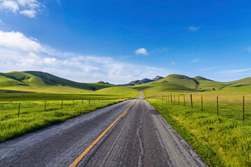 Fototapeta na wymiar Country road in country, pasture, field, hills