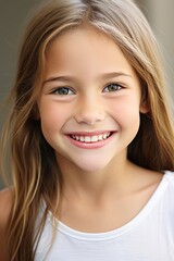 Fototapeta premium Pretty Young Girl Smiling to Camera Showing White Teeth Close-up Portrait on a Plane Background