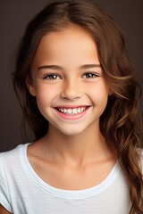 Fototapeta premium Pretty Young Girl Smiling to Camera Showing White Teeth Close-up Portrait on a Plane Background