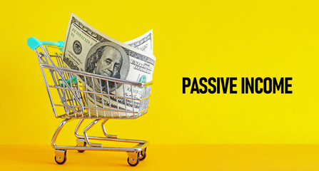 Passive income is shown using the text and photo of trolley with dollars