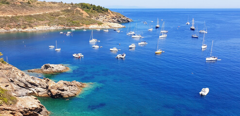 Panorama of the azure sea and boats near Barbarossa beach, Elba island.