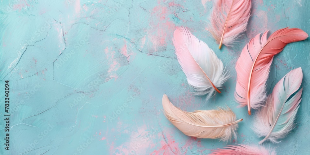 Aufkleber a high-angle shot displaying a variety of delicate feathers with soft pastel hues arranged over a te