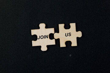 Jigsaw puzzle pieces with word JOIN US Business concept