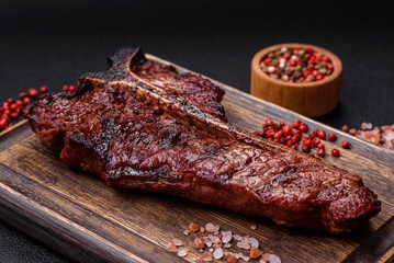 Delicious juicy beef tbone steak with salt, spices and herbs