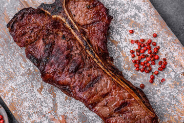 Delicious juicy beef tbone steak with salt, spices and herbs
