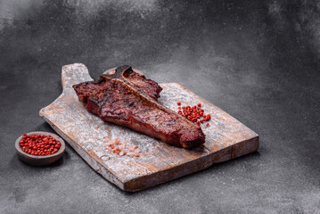 Delicious juicy beef tbone steak with salt, spices and herbs