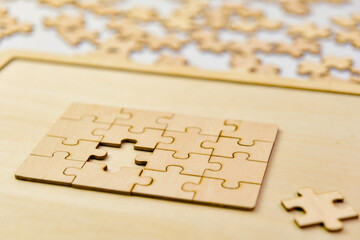 Jigsaw puzzle pieces on a wooden board business success concept