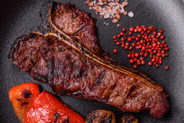 Delicious juicy beef tbone steak with salt, spices and herbs
