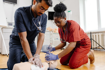 Healthcare professionals in scrubs performing medical procedure
