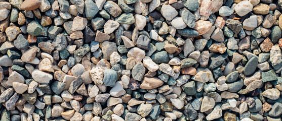 The background is made of stones of different sizes and colors. The texture of natural stones.