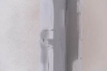 Applying decorative putty. White abstract texture of surface covered with putty