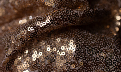 Horizontal shiny wavy shot texture for wallpaper.Gold sequined fabric. Abstract background