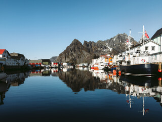 Henningsvaer village in Lofoten islands, houses and boats traditional norwegian architecture,...