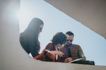 Colleagues or business partners in a casual meeting outside with a focus on project planning and...