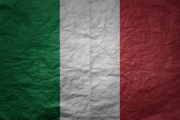big national flag of italy on a grunge old paper texture background