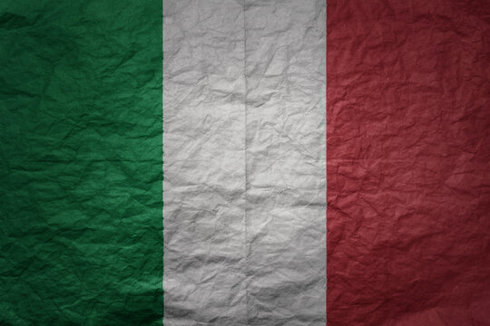 big national flag of italy on a grunge old paper texture background