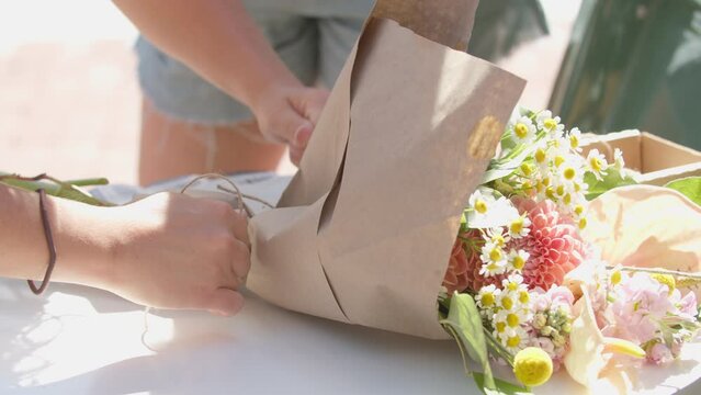 woman preparing flower bouquet